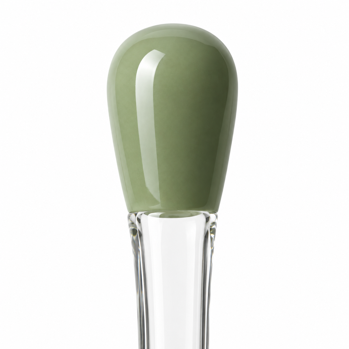 Close-up of green handle on glass spoon