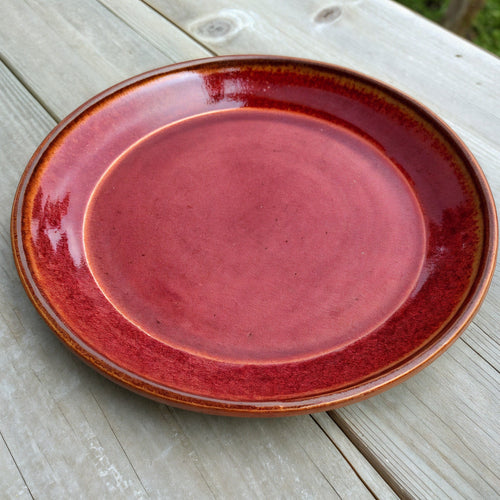 Remoxila Crimson Red Plate — three-quarter angled view showing full top face and glaze