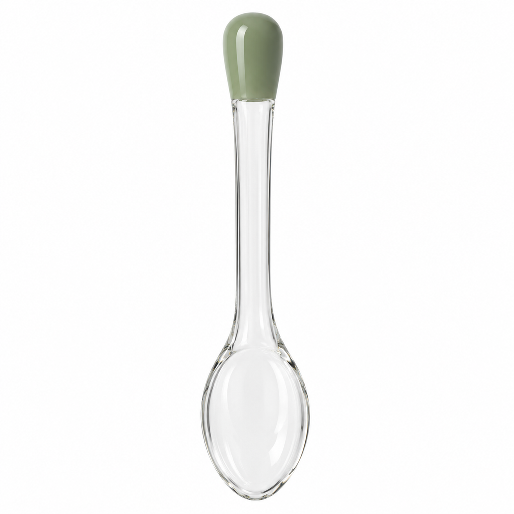 Glass spoon with green handle, front view
