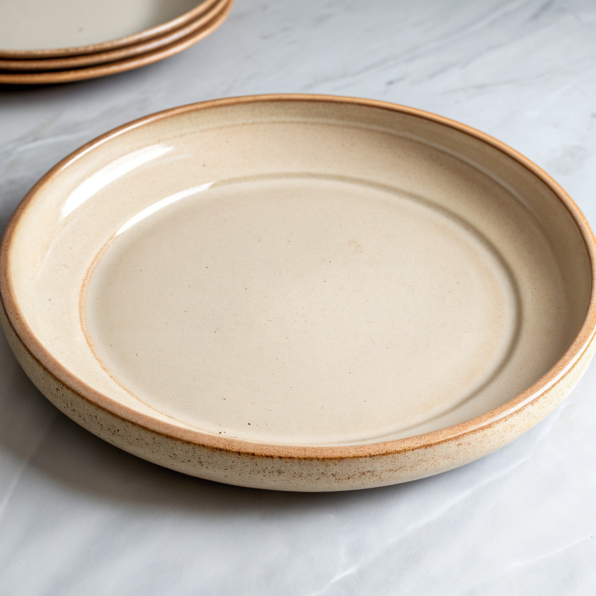 Remoxila Soft Beige Plate — three-quarter angled view showing full top face and rim