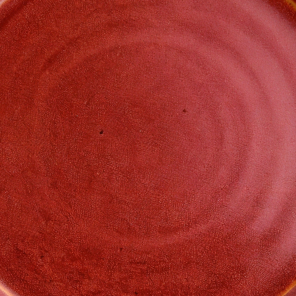 Remoxila Crimson Red Plate — macro close-up of glaze surface texture at center