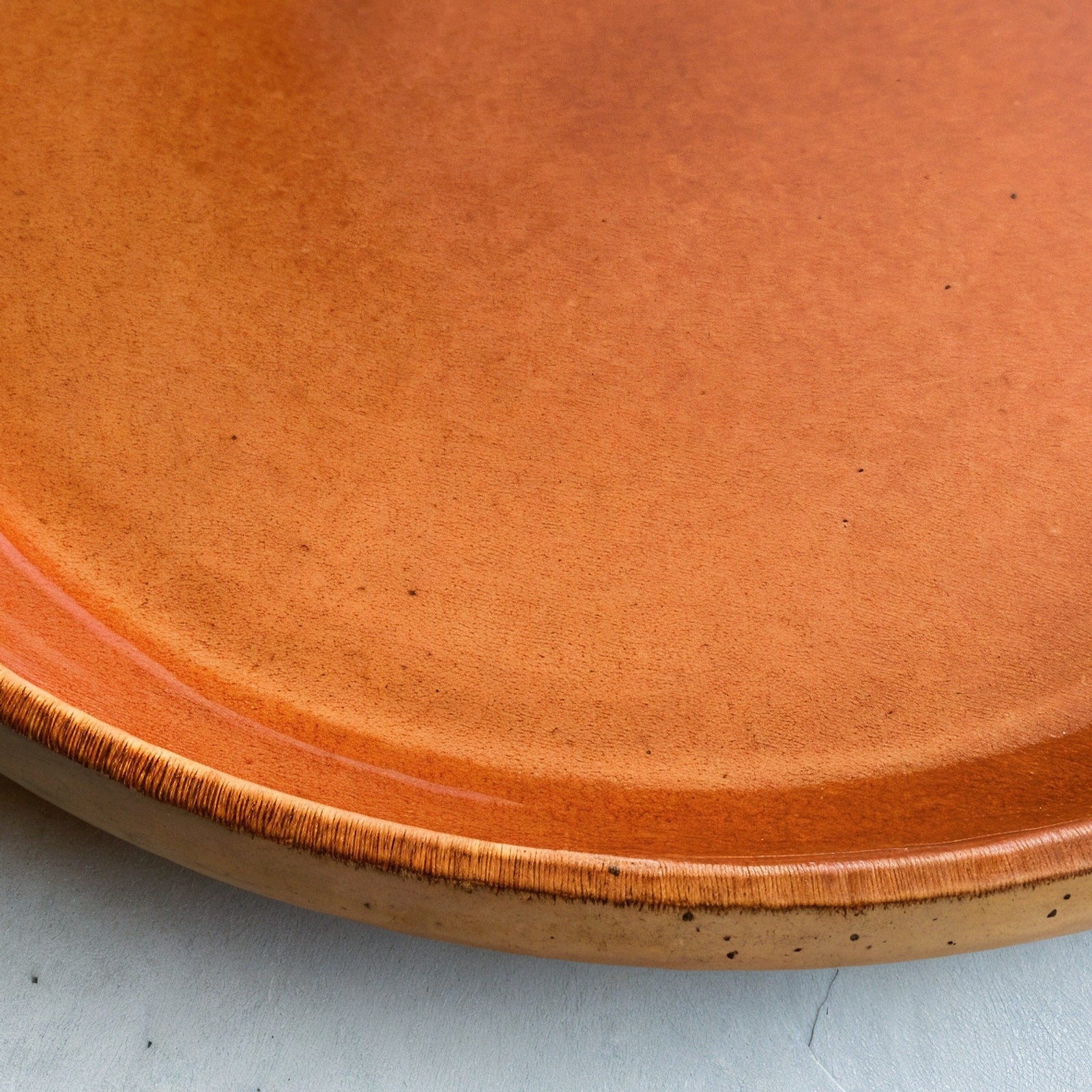 Remoxila Burnt Orange Plate — macro rim detail, showing glaze pooling